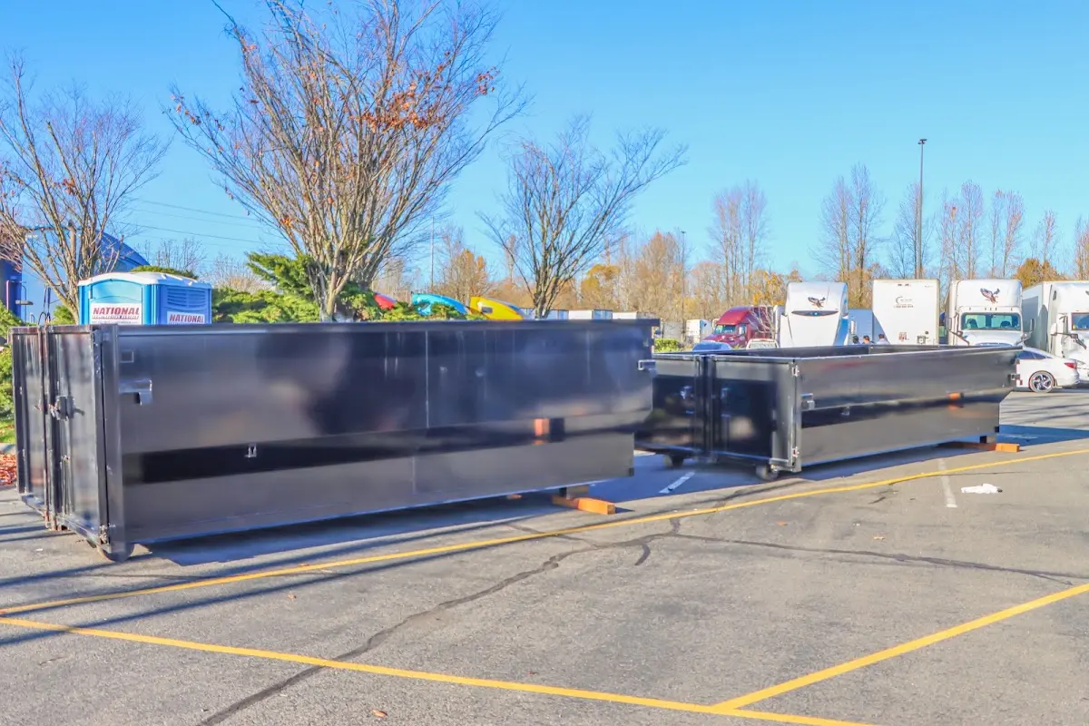 Professional dumpster rental service with roll-off container on residential driveway in Philipstown